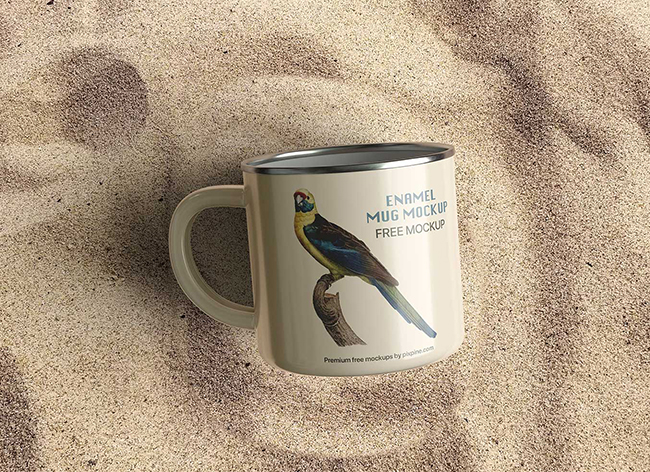Free Enamel Coffee Mug on Sand Mockup PSD