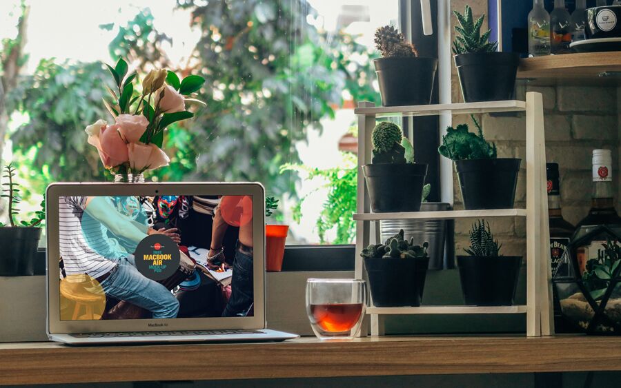 Front View of a MacBook Air in a Green Environment Mockup FREE PSD